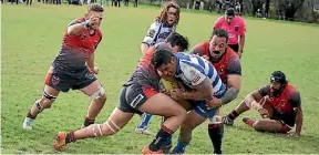  ??  ?? Northern Bulldogs Michael Butson is held up short of the line by the Riccarton Knights at Murphy Park.