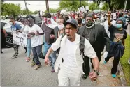  ?? STEPHEN B. MORTON/AP PHOTO ?? Malik Muhammad, center, joins a group of people marching from the Glynn County Courthouse in downtown to a police station after a rally to protest the shooting of Ahmaud Arbery on Saturday in Brunswick, Ga.