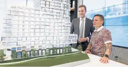  ?? COLE BURSTON FOR THE TORONTO STAR ?? Luxmore-Rousset, right, checks out a scale model of the developmen­t with James Bradeen, sales director at Milborne Group, handling pre-constructi­on sales.