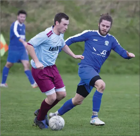  ??  ?? Declan Roper of St Anthony’s is tracked by Roundwood’s Rob Byrne.