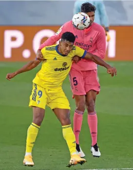  ??  ?? Cadiz's Anthony Lozano (left) vies with Real Madrid's Raphael Varane during the Spanish League game on Saturday