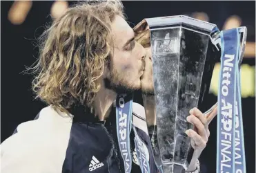  ?? PICTURE: JOHN WALTON/PA ?? 0 Stefanos Tsitsipas kisses the ATP Finals trophy after his stunning victory.