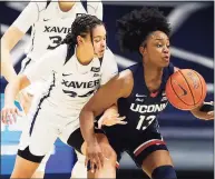  ?? Gary Landers / Associated Press ?? UConn guard Christyn Williams, right, takes control of a loose ball in front of Xavier guard Shaulana Wagner during the first half on Saturday.