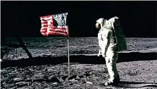  ??  ?? Leap for mankind: Buzz Aldrin walks on the Moon in 1969 and (right) the Mail’s historic front page