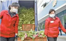  ?? Reuters-Yonhap ?? Workers wearing protective face masks carry vegetables to a greengroce­r’s shop for distributi­on to households amid growing fears over the spread of COVID-19 in Pyongyang, North Korea in this photo taken on May 16, and released by Kyodo on May 17.