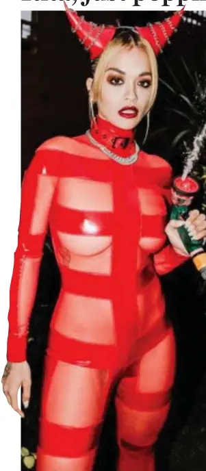  ??  ?? Devilish disguise: Rita Ora, hose in hand, in her Halloween outfit