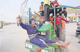  ?? MANISH SWARUP/AP ?? Farmers hail news of the repeal of farm laws pushed by the prime minister that they were protesting against, in Singhu, on the outskirts of New Delhi, India, Friday.