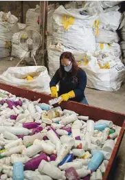  ?? ?? A worker cleans discarded plastic bottles in the factory of social enterprise The Plastic Flamingo or The Plaf, in Muntinlupa, Philippine­s.