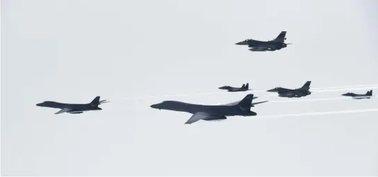  ??  ?? US Air Force B-1B bombers, left and second from left, fly with South Korean and US fighter jets over the Korean peninsula on Saturday. (AP)