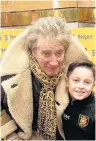  ??  ?? Some fans have all the luck A young Rovers ball boy meets Sir Rod