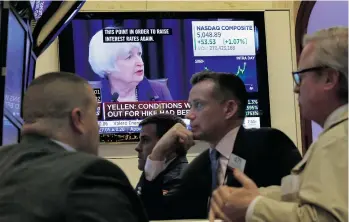  ?? RICHARD DREW / THE ASSOCIATED PRESS ?? Federal Reserve chair Janet Yellen’s news conference is shown on a TV screen on the floor of the New York Stock Exchange on Wednesday. The Fed’s move to lift its key rate by a quarter-point
ended a seven-year period of near-zero rates.