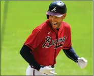  ?? Associated Press ?? Grand slam: Atlanta Braves' Freddie Freeman reacts as he runs along the third base line after hitting a grand slam home run in the sixth inning of a baseball game against the Washington Nationals in Atlanta, in this Sunday, Sept. 6, 2020, file photo. The NL MVP, Freeman has followed his big season with the Braves with an even more memorable offseason. He and his wife have two baby boys, including one from a surrogate mother. He calls his new babies his “twins with a twist.”