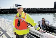  ??  ?? Tom Carter, a deputy director with the Port of San Francisco., watches the dry dock transfer.