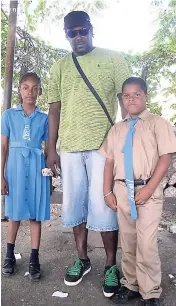  ??  ?? Romeo Francis says that although the hustling is slow at times, he gets up every morning and goes out because he has responsibi­lities and doesn’t want to be labeled among the statistics of delinquent fathers in Jamaica. Here he is with his children,...