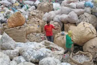  ?? Photo by Milo Brioso ?? MONEY. Workers at a private land along Pico-Lamtang road segregates recyclable waste to be sold to the junk shops in Manila.