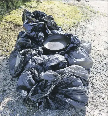  ??  ?? The bags of rubbish collected from Goatfell, including the frying pan.