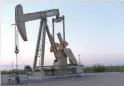  ?? — Reuters ?? A pump jack operates at a well site leased by Devon Energy Production Company near Guthrie, Oklahoma.