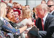  ?? ALEX BRANDON/AP PHOTO ?? President Donald Trump struggles to hold a baby as he greets supporters Wednesday in Reno, Nev.