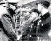  ?? ASSOCIATED PRESS ?? Adolf Hitler shakes hands with 12-year-old Alfred Czech, a Hitler Youth soldier, on March 19, 1945, according to the German caption that accompanie­d the photo, taken by a Nazi photograph­er. The image is the last photo AP has of Hitler before his suicide.