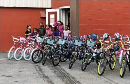  ?? NICHOLAS BUONANNO - NBUONANNO@TROYRECORD.COM ?? Kids from the Troy Boys and Girls Club get surprised Wednesday afternoon with new bikes for them donated by Sunmark Federal Credit Union.