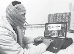  ??  ?? File photo shows a Syrian refugee from Damascus, who identified himself as Abu Shadi, using his computer to check on news from Syria in his bedroom at a house he rents from a Jordanian family in the Nazzal district of Amman. — AFP photo