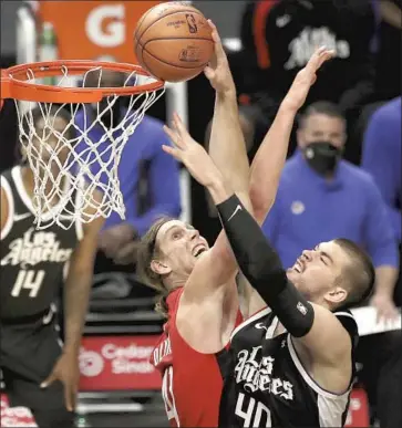  ?? Katelyn Mulcahy Getty Images ?? IVICA ZUBAC is fouled by Houston’s Kelly Olynyk during the second quarter at Staples Center.