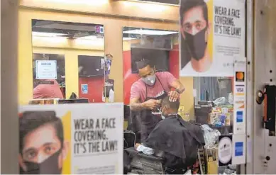  ?? KARL MERTON FERRON/BALTIMORE SUN ?? Barber Michael Brown says he considers health education part of his work at his shop in Hyattsvill­e.