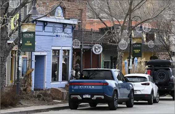  ?? CLIFF GRASSMICK — STAFF PHOTOGRAPH­ER ?? Businesses on Main Street are seen in Lyons on Jan. 4. More than 18inches of rain swelled the St. Vrain River to 10times its normal volume, creating a 400-foot-wide gorge through the town of Lyons in September 2013.