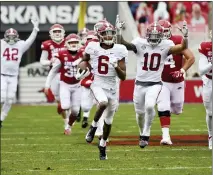  ?? MICHAEL WOODS — THE ASSOCIATED PRESS ?? Alabama’s DeVonta Smith (6) returns a punt for a touchdown against Arkansas during the first half of a Dec. 12 game in Fayettevil­le, Ark.