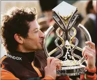  ?? Christophe­r Furlong / Getty Images ?? Winning jockey Sam Waley-Cohen celebrates with the Grand National Trophy after riding Noble Yeats to victory in the Grand National on Saturday.