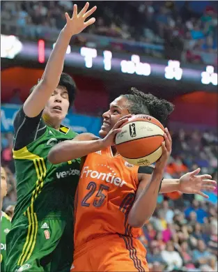  ?? TIM MARTIN/THE DAY ?? Alyssa Thomas of the Sun (25) shoots over Ramu Tokashiki of the Storm during the first half of Tuesday night’s WNBA game at Mohegan Sun Arena.