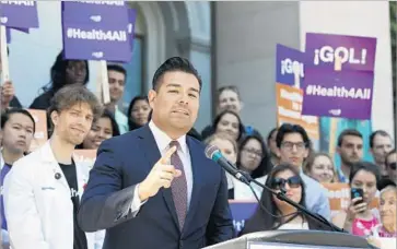  ?? Rich Pedroncell­i Associated Press ?? STATE SEN. RICARDO LARA (D-Bell Gardens) speaks at a rally in Sacramento on May 16. Lara and state Sen. Toni Atkins (D-San Diego) are sponsoring a bill to enact a statewide single-payer healthcare plan.