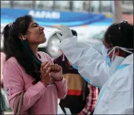  ??  ?? A health worker collects a swab sample covid-19 on Monday in Jammu, India. (AP/Channi Anand)
to
test a woman
for