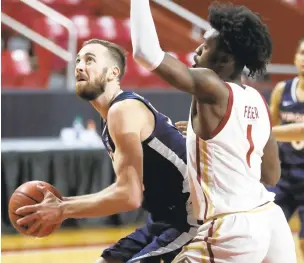  ?? MICHAEL DWYER/ASSOCIATED PRESS ?? Virginia’s Jay Huff, left, looks to shoot against Boston College’s CJ Felder on Saturday. Huff finished with 18 points, eight rebounds and five blocks in the Cavaliers’ 61-49 victory.