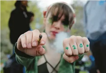  ?? LEONARDO MUNOZ/GETTY-AFP ?? Time to party: A marijuana smoker exhales during a 420 celebratio­n Saturday at Washington Square Park in New York City. April 20 is an unofficial internatio­nal countercul­ture celebratio­n of cannabis, the date reportedly arising from the 4:20 p.m. meeting time of a group of 1970s California high school students whose term took on a life of its own.