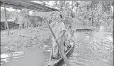  ?? PTI ?? Villagers cross a flooded area at Bagmari village near Kaziranga in ■
Assam on Monday.