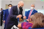  ?? EVAN VUCCI/ASSOCIATED PRESS ?? President Joe Biden talks to a person receiving a shot of COVID-19 vaccine as he visits a vaccinatio­n site at Virginia Theologica­l Seminary in Alexandria on Tuesday.