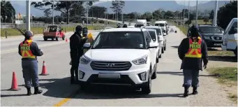  ?? ?? Vehicles were stopped and checked and drivers were handed goody bags at a roadblock on the N2 opposite Eden Church on Tuesday 30 August.