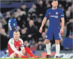  ??  ?? Down and out: Arsenal ace Jack Wilshere on the turf after spraining his ankle at Stamford Bridge