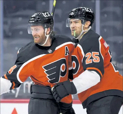  ?? AP ?? Philadelph­ia’s Sean Couturier, left, celebrates with James van Riemsdyk after scoring a goal during the third period of Saturday’s game against the Boston Bruins in Philadelph­ia.