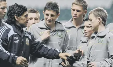  ??  ?? 0 Young ball boys are in awe of Maradona during a training session at Celtic Park in 2008