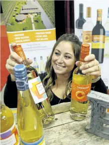  ?? CLIFFORD SKARSTEDT/EXAMINER ?? Sara Coltman of Sandbanks Winery sets up her booth during The Good Food and Wine Show showcasing Ontario's culinary community on Friday at the Morrow Building. Visitors indulged in pub fare, cultural cuisines, craft beer and spirits. The show wraps up...