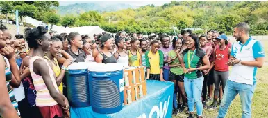  ?? CONTRIBUTE­D ?? Olympian Christania Williams (second right, front) shares nuggets of advice with student athletes from the Edwin Allen High School’s track and field team.