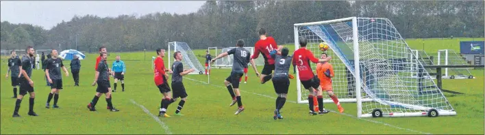  ?? Photo Tam Borland. ?? Arran players jump highest in a goalmouth scramble.