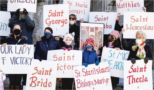  ?? ANTHONY VAZQUEZ/SUN-TIMES PHOTOS ?? Protesters hold signs and photos of various churches and demand Cardinal Blase Cupich stop the liquidatio­n of more than 25 churches targeted for closure by the archdioces­e during a news conference Wednesday outside St. Anthony Church at 518 W. 28th Place in Bridgeport.