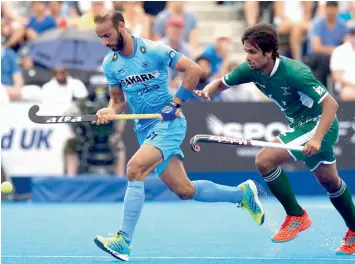  ?? — PTI ?? Ramandeep Singh (left) is chased by Pakistan defender Bilal Muhammad Aleem in their Hockey World League SemiFinal Pool B match in London on Sunday. India won 7-1 to seal their place in the quarter-finals.