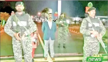  ?? — Reuters photo ?? Abhinandan, stands under armed escort near Pakistan-India border in Wagah, Pakistan in this image from a video footage.