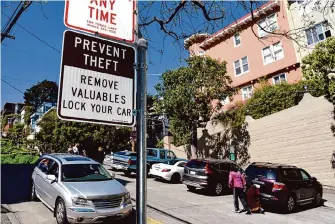  ?? Michael Short/Special to the Chronicle 2016 ?? Signs warn people not to leave valuables in their cars near Lombard Street. A Chronicle analysis shows a spike in car break-ins since 2010 has set San Francisco apart from other cities in the state.