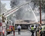  ?? Arkansas Democrat-Gazette/JOHN SYKES JR. ?? Firefighte­rs battle the May 1 fire that destroyed the Ozark Country Restaurant on Little Rock’s Keightley Drive.