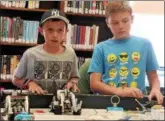  ?? LEAH MCDONALD — ONEIDA DAILY DISPATCH ?? Jacob Higgins, 10, left, takes a practice run with his robot while Sullivan Tifft, 11, watches at the Oneida Public Library on Friday, Aug. 24, 2018.